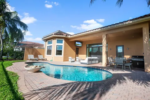 a view of a park with a sign board and large trees