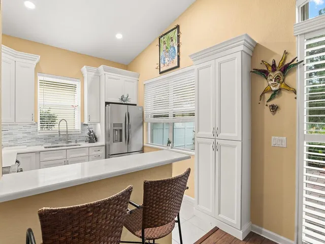 a kitchen with refrigerator and window