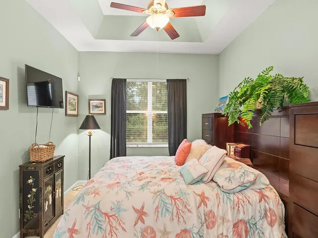 a bedroom with a bed and a television