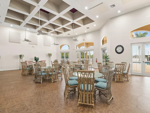 a view of a dining room with furniture and a chandelier