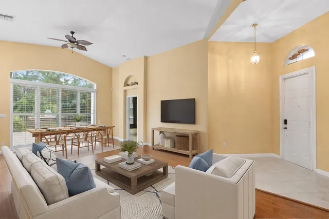 a living room with furniture a fireplace and a flat screen tv