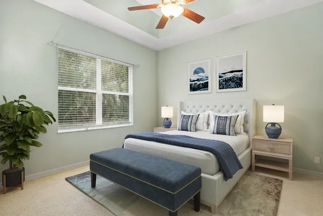 a bedroom with a large bed and a potted plant