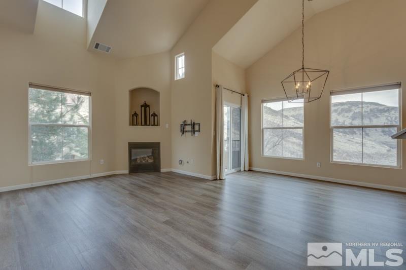 9050 Double R Boulevard, Unit 724 Reno, NV 89511 - Photo 1 of 18 a view of an empty room with a window and wooden floor
