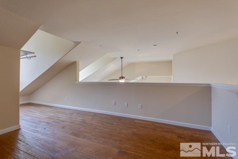 9050 Double R Boulevard, Unit 724 Reno, NV 89511 - Photo 13 of 18 a view of an empty room with wooden floor