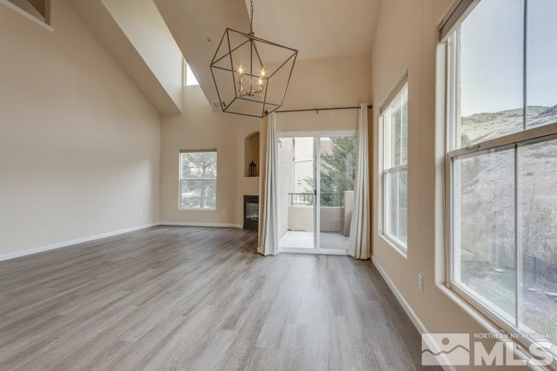 9050 Double R Boulevard, Unit 724 Reno, NV 89511 - Photo 2 of 18 a view of empty room with wooden floor and fan