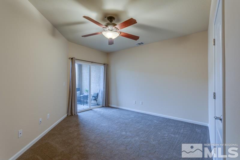 9050 Double R Boulevard, Unit 724 Reno, NV 89511 - Photo 7 of 18 an empty room with closet and fan