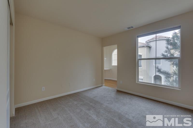 9050 Double R Boulevard, Unit 724 Reno, NV 89511 - Photo 9 of 18 an empty room with windows and closet
