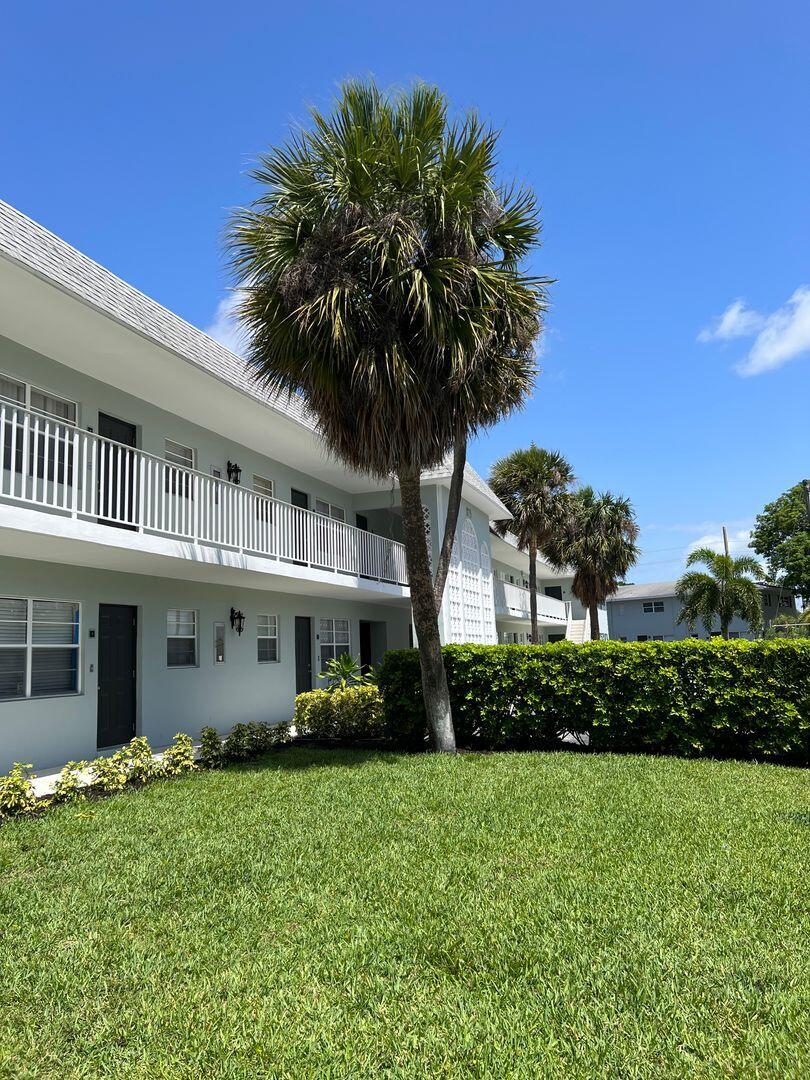 480 West Camino Real, Unit 31 Boca Raton, FL 33432 - Photo 13 of 22 a front view of a house with a garden