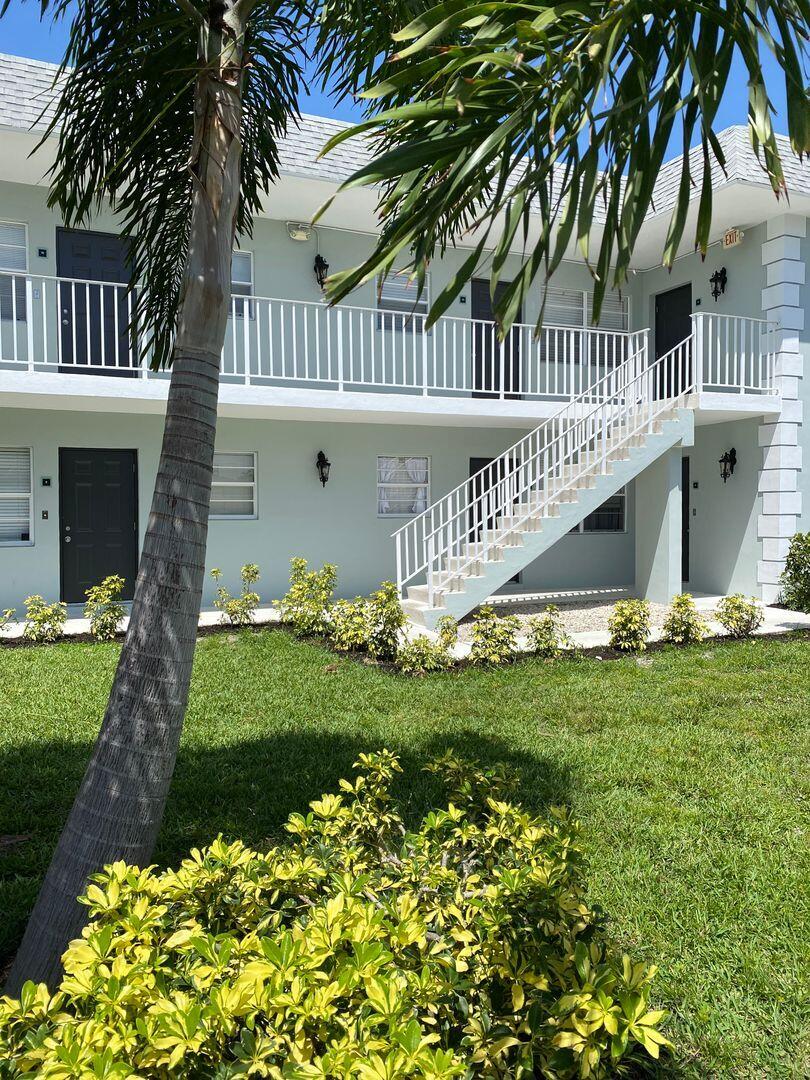 480 West Camino Real, Unit 31 Boca Raton, FL 33432 - Photo 15 of 22 a front view of a house with a yard