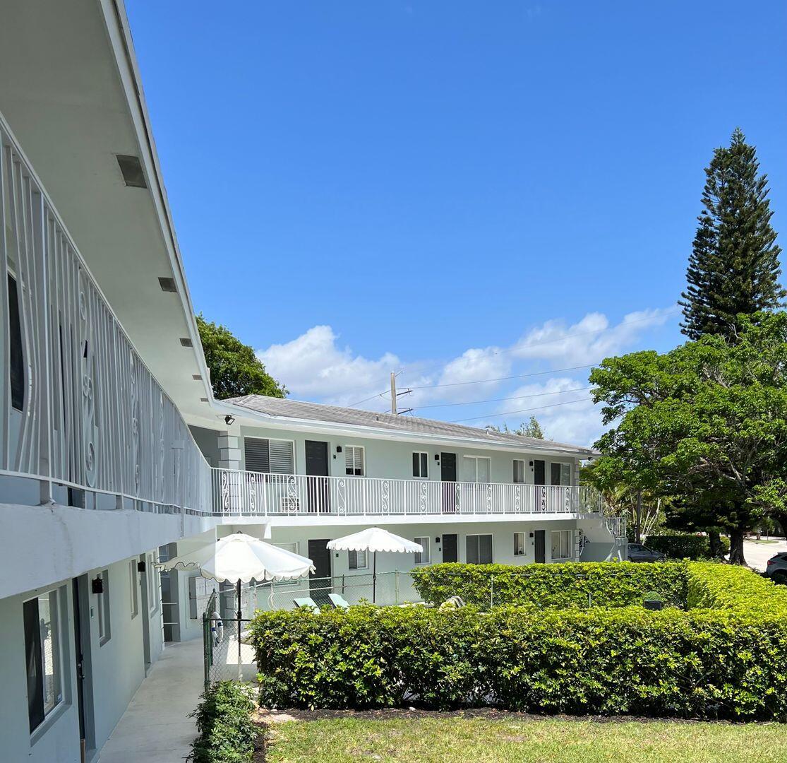 480 West Camino Real, Unit 31 Boca Raton, FL 33432 - Photo 18 of 22 a front view of a house with a yard