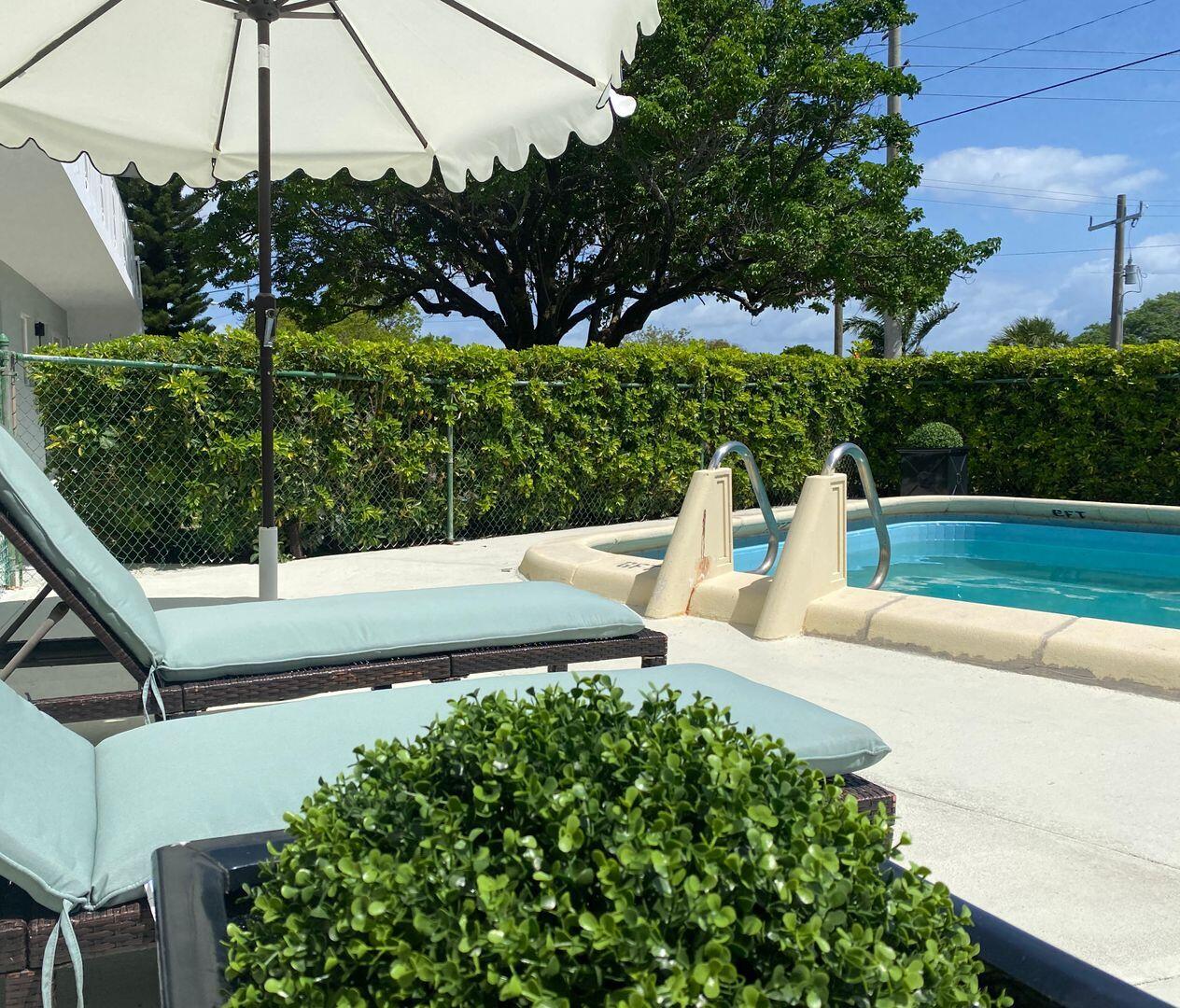 480 West Camino Real, Unit 31 Boca Raton, FL 33432 - Photo 20 of 22 a view of a bench in a garden