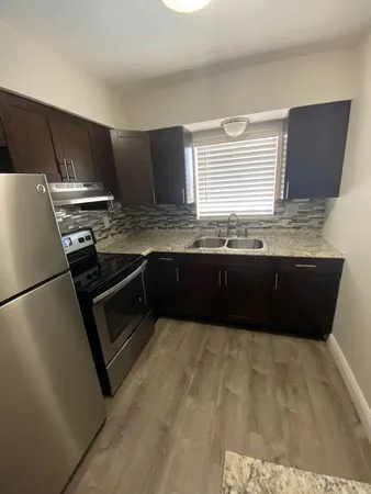 a kitchen with stainless steel appliances granite countertop a sink counter space and cabinets
