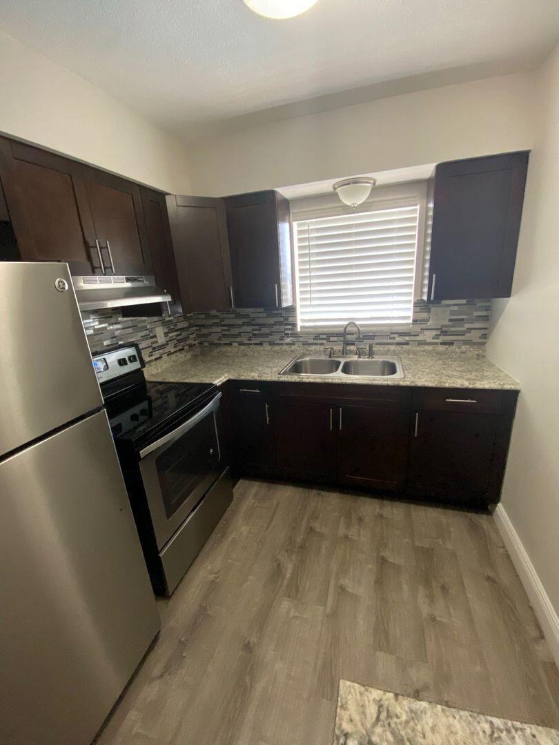 480 West Camino Real, Unit 31 Boca Raton, FL 33432 - Photo 22 of 22 a kitchen with stainless steel appliances granite countertop a sink counter space and cabinets
