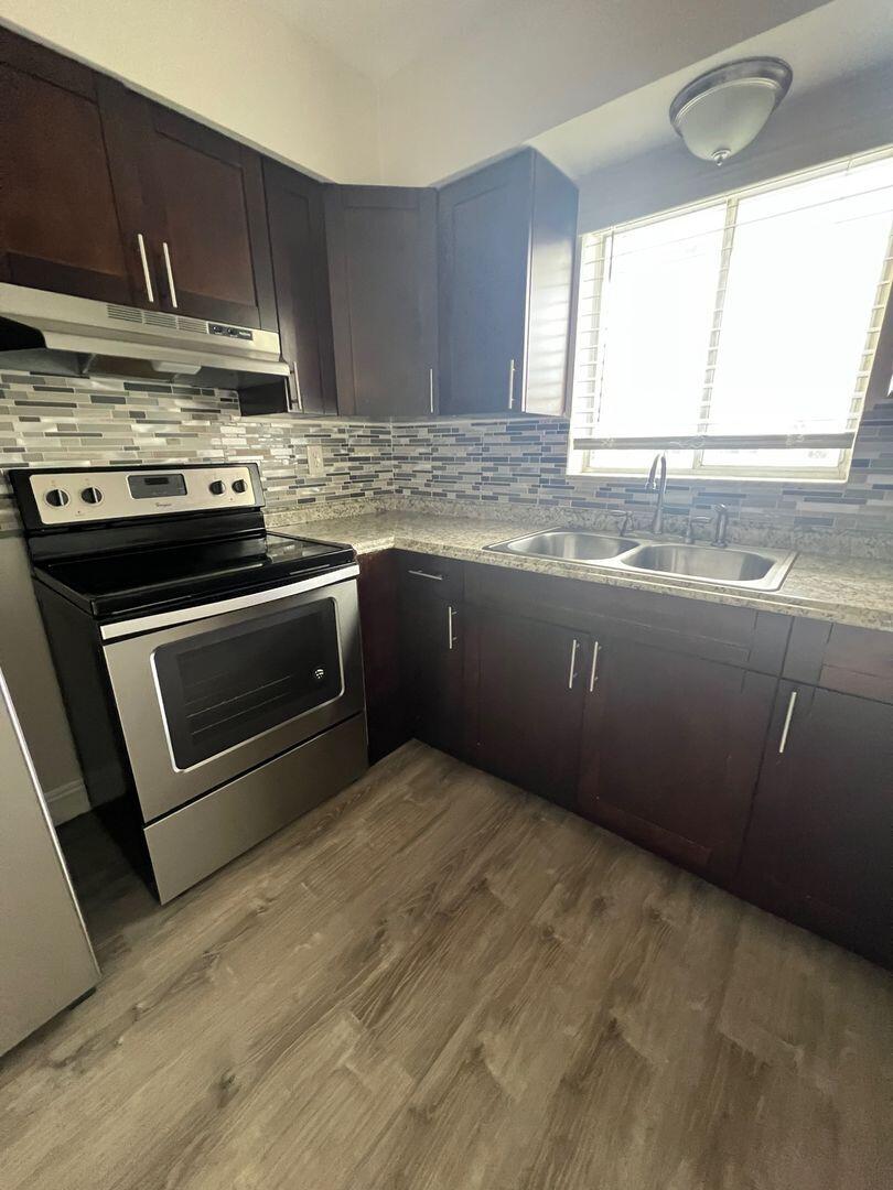 480 West Camino Real, Unit 31 Boca Raton, FL 33432 - Photo 3 of 22 a kitchen with granite countertop a sink and a stove