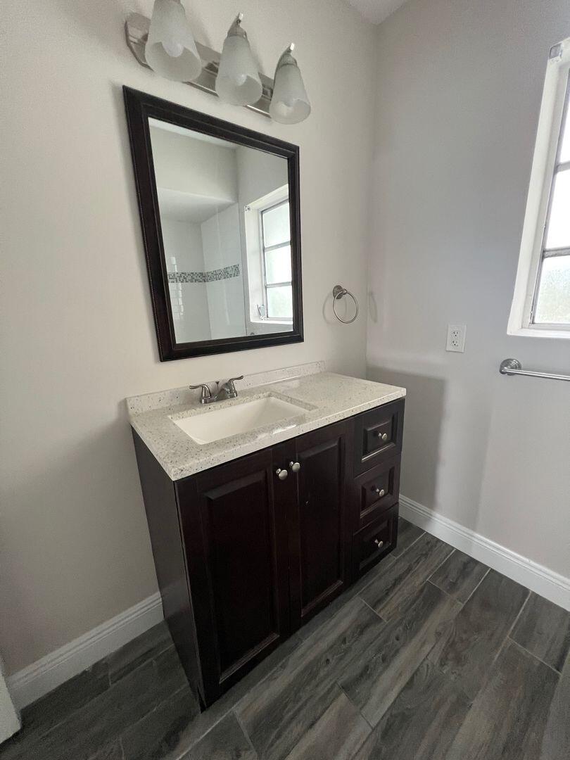 480 West Camino Real, Unit 31 Boca Raton, FL 33432 - Photo 7 of 22 a bathroom with a sink vanity and mirror