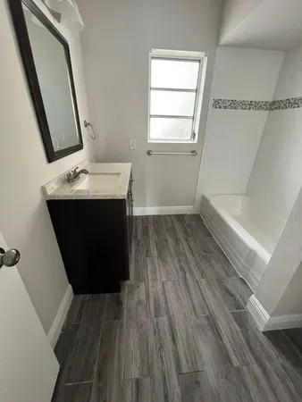 a room with a sink and a mirror