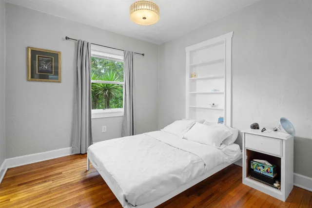 a bedroom with a bed and a fireplace