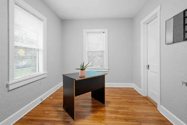 a view of a room with wooden floor windows and cabinet