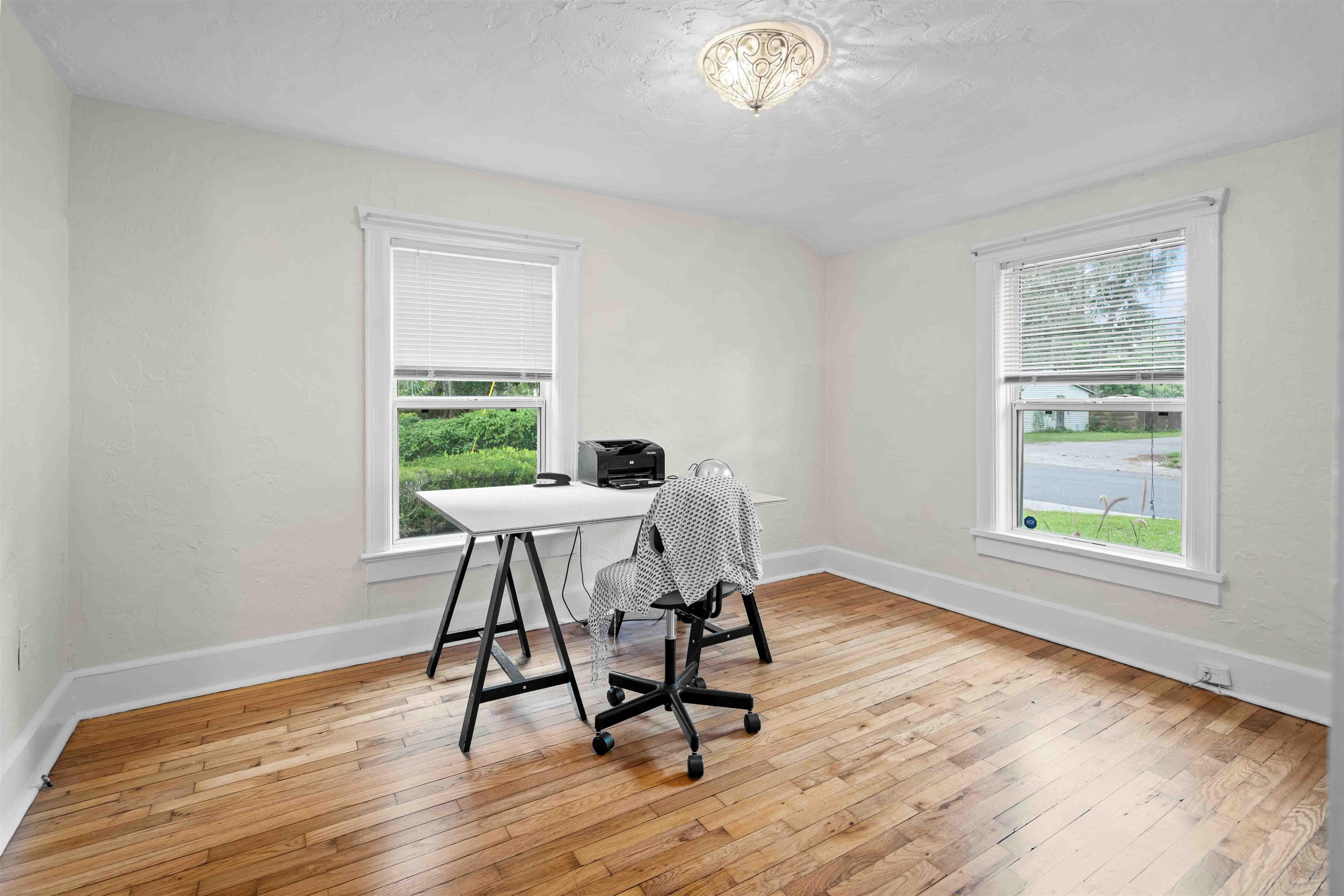 716 Northeast 10th Avenue Gainesville, FL 32601 - Photo 15 of 29 a dining room with wooden floor and a window