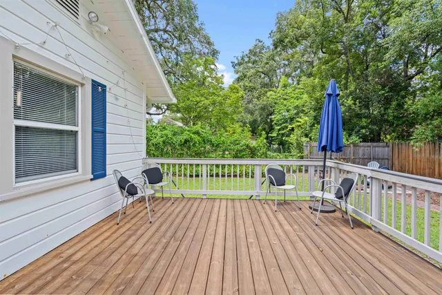 a view of deck with a table and chairs and wooden floor
