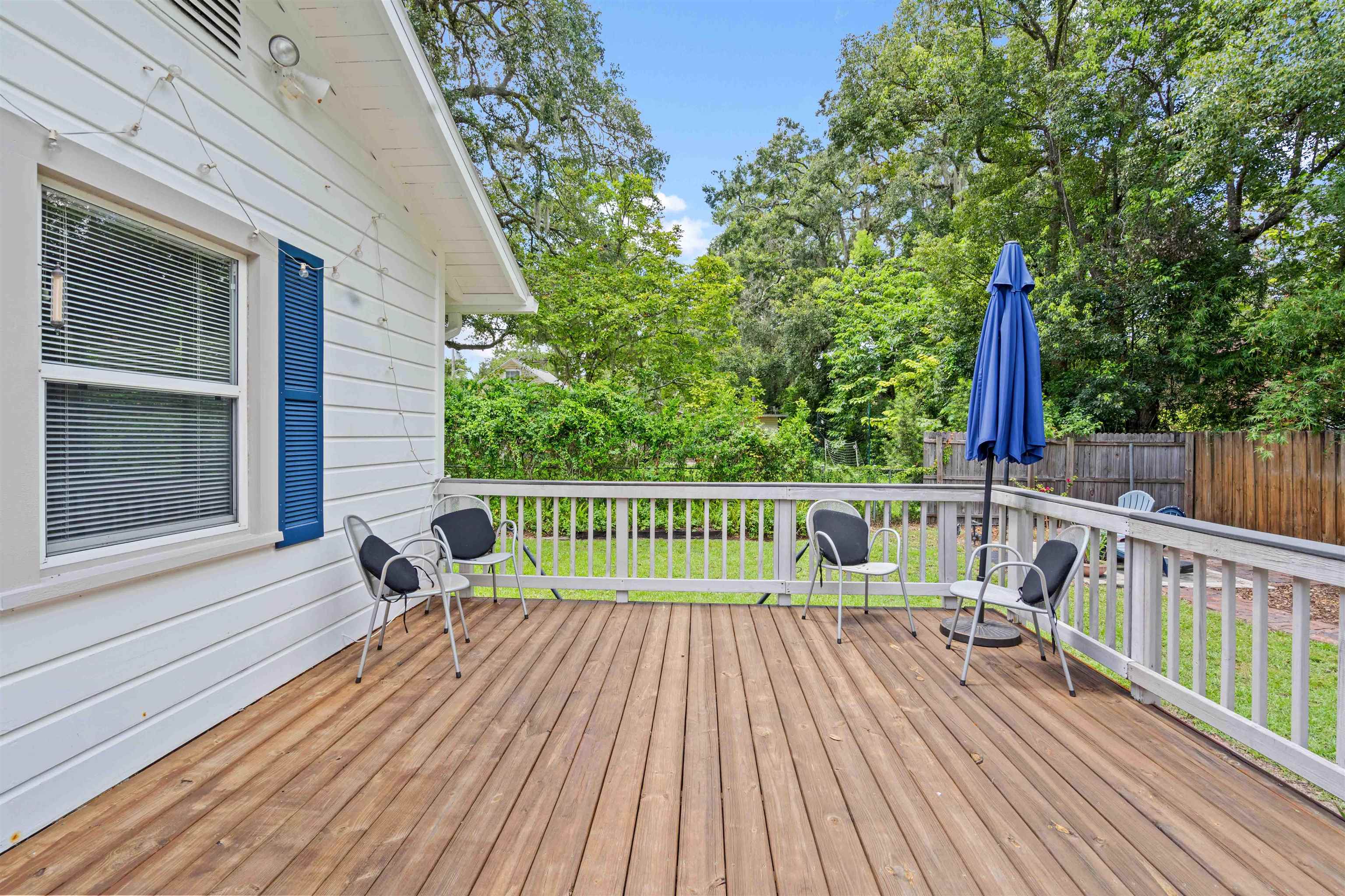 716 Northeast 10th Avenue Gainesville, FL 32601 - Photo 19 of 29 a view of deck with a table and chairs and wooden floor