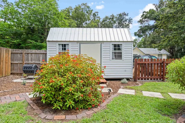 a view of a house with a yard and plants