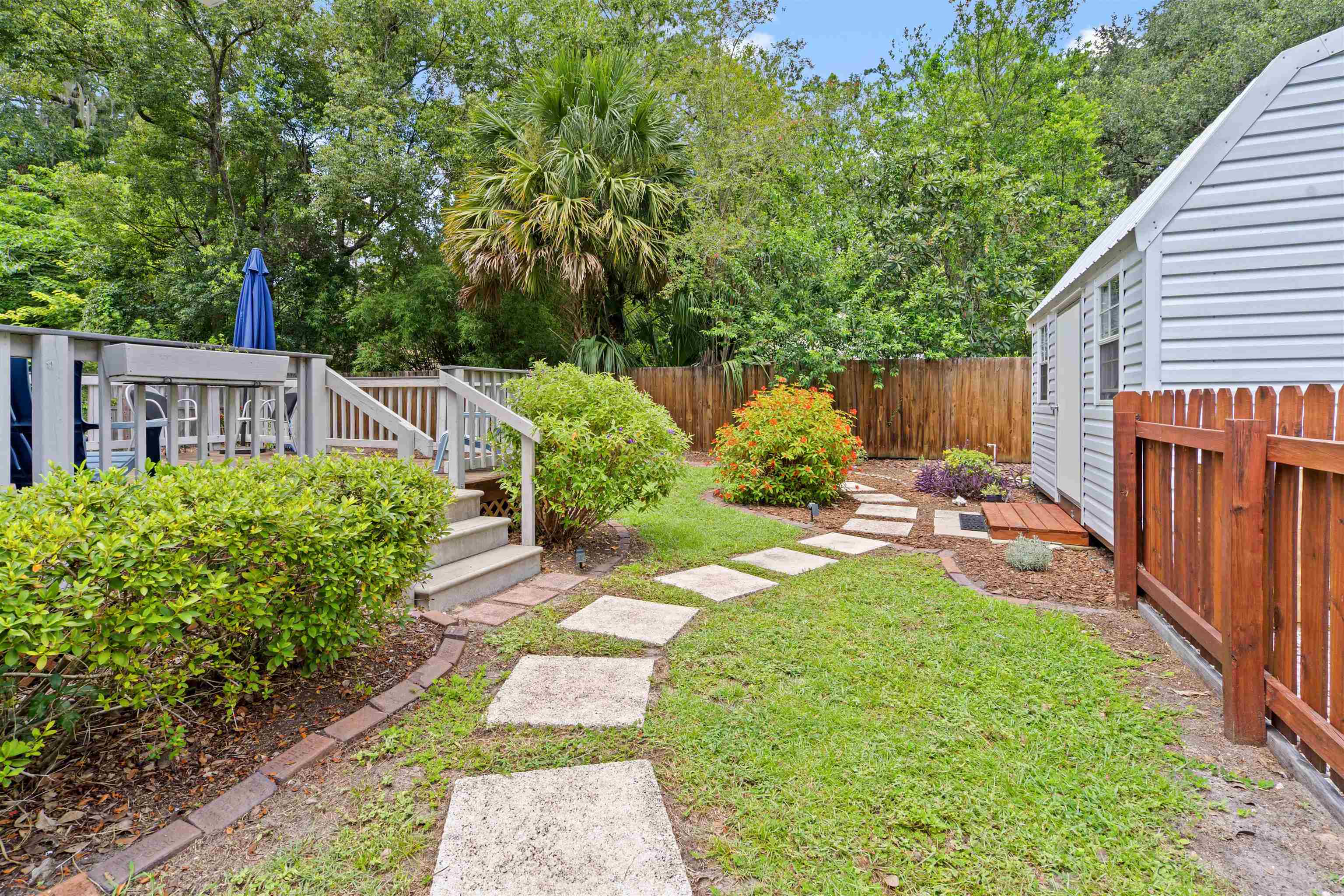 716 Northeast 10th Avenue Gainesville, FL 32601 - Photo 26 of 29 a view of a backyard with potted plants and large tree