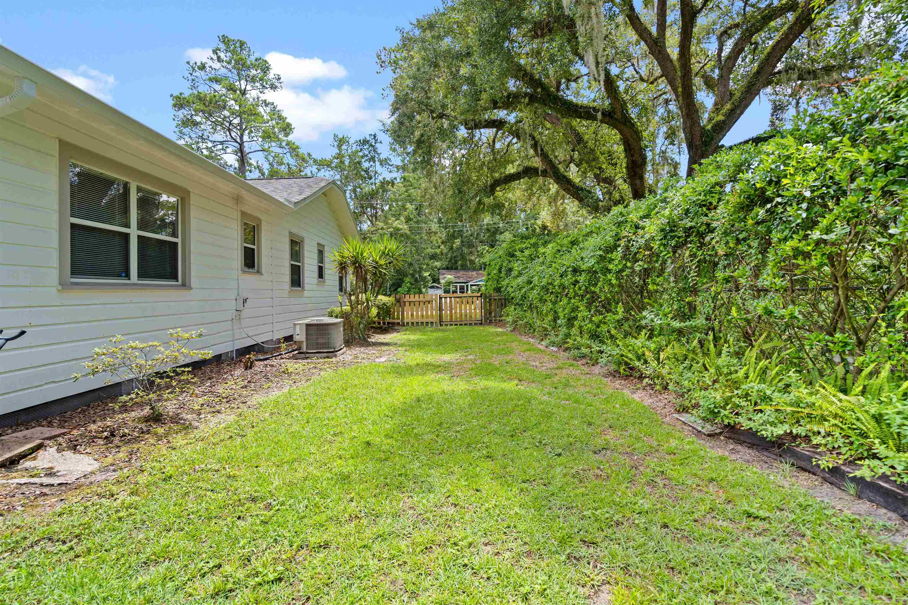 716 Northeast 10th Avenue Gainesville, FL 32601 - Photo 27 of 29 a backyard of a house with table and chairs