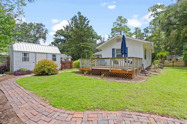 a view of a house with a yard porch and sitting area