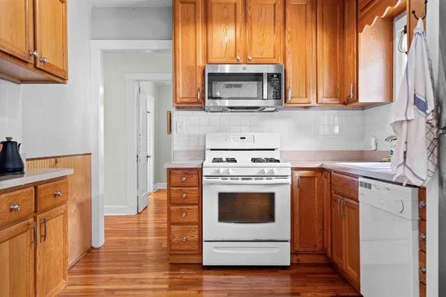 a kitchen with a stove microwave and sink