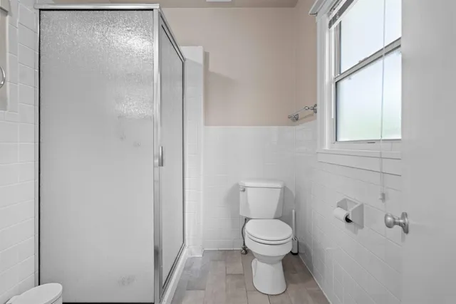 a bathroom with a toilet and a shower