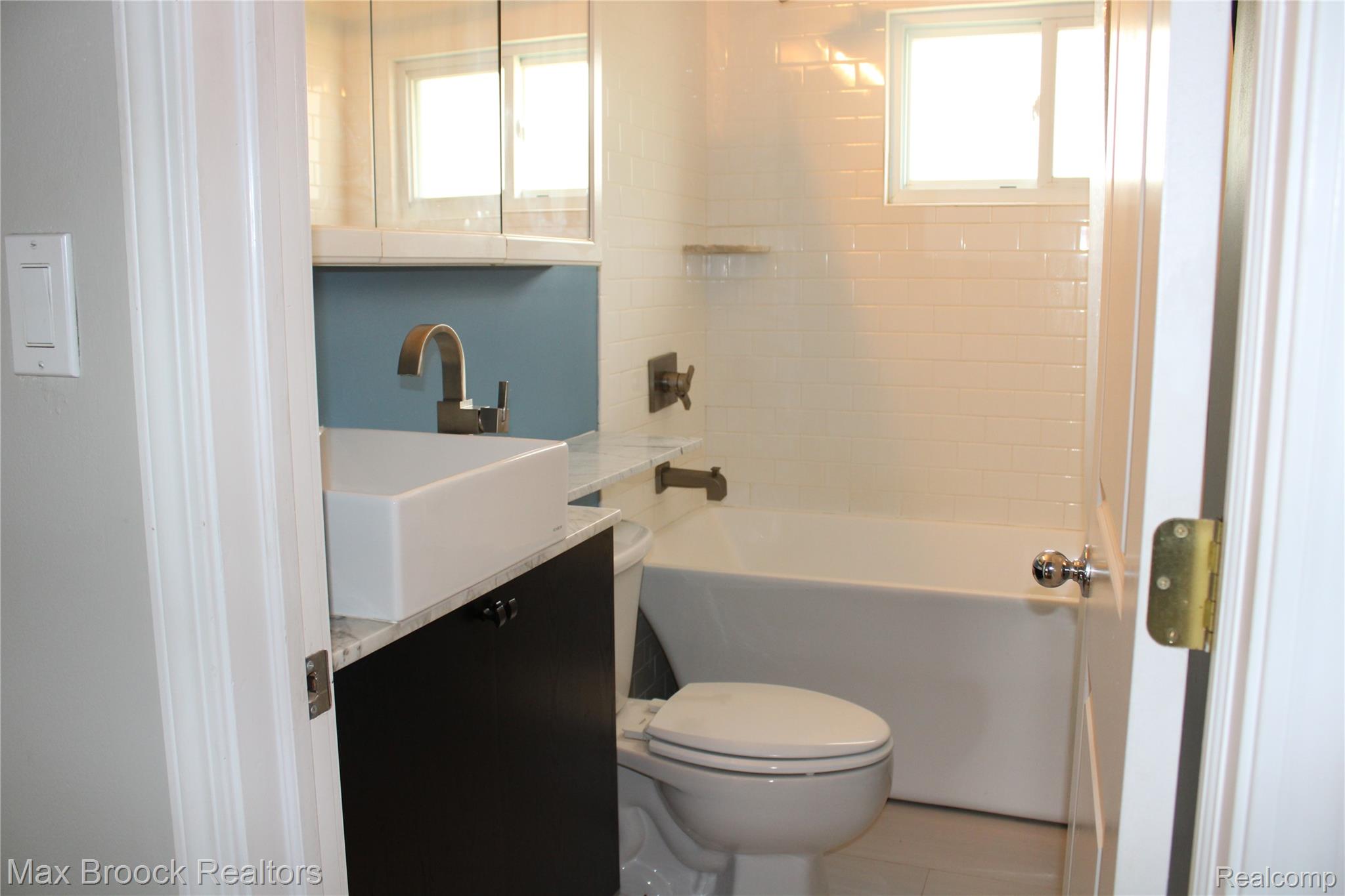 3800 Normandy Road, Unit 2 Royal Oak, MI 48073 - Photo 5 of 11 Modern vanity with vessel sink, brushed nickel faucet, and integrated storage