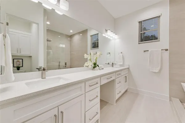 a bathroom with a double vanity sink mirror and double