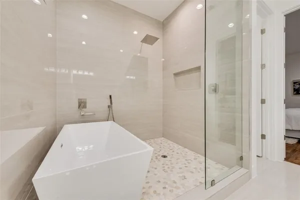 a bathroom with a bathtub and a shower