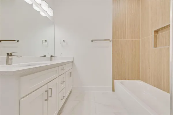 a bathroom with a double vanity sink a and a mirror