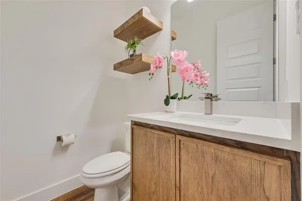 a bathroom with a sink vanity and toilet