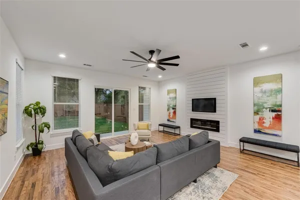 a living room with furniture tv and a large window