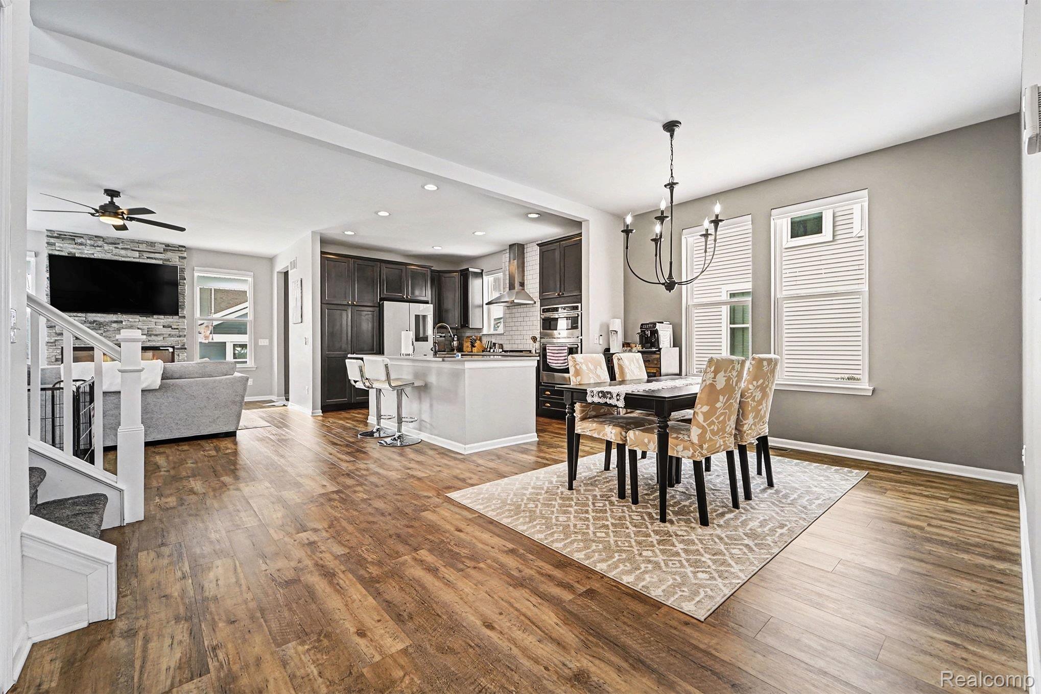2471 Massoit Road Royal Oak, MI 48073 - Photo 10 of 49 Dining area featuring stairs, a chandelier, recessed lighting, dark wood-style floors, and ceiling fan
