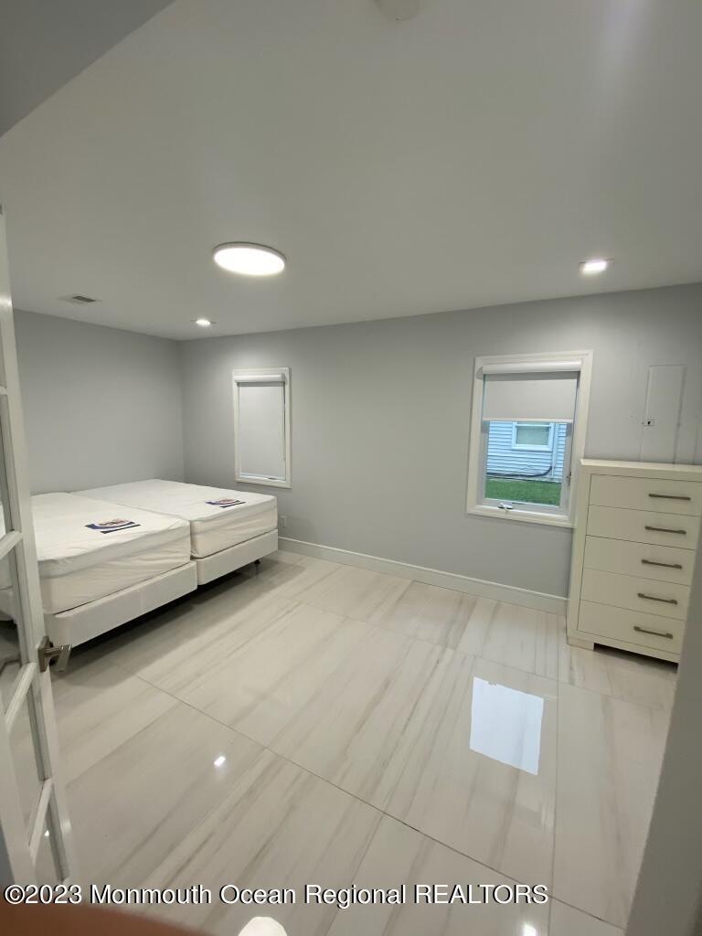 258 Norgrove Avenue Long Branch, NJ 07740 - Photo 11 of 16 a bedroom with a bed and a view of kitchen