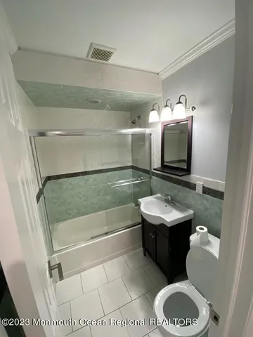 a bathroom with a sink toilet and tub