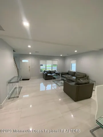 a living room with furniture and a gym
