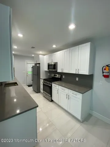 a kitchen with stainless steel appliances granite countertop a sink and a stove