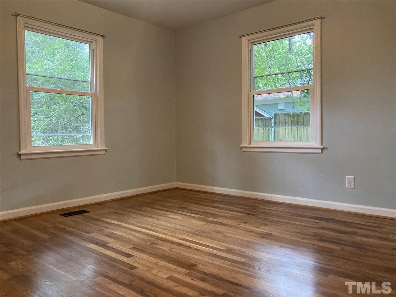 2433 Stevens Road Raleigh, NC 27610 - Photo 11 of 15 an empty room with wooden floor and windows