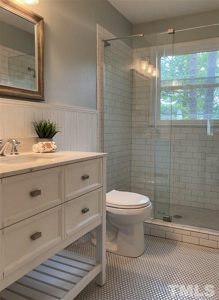 2433 Stevens Road Raleigh, NC 27610 - Photo 13 of 15 a bathroom with a sink a toilet and shower