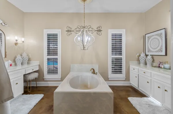 a spacious bathroom with double vanity and a mirror