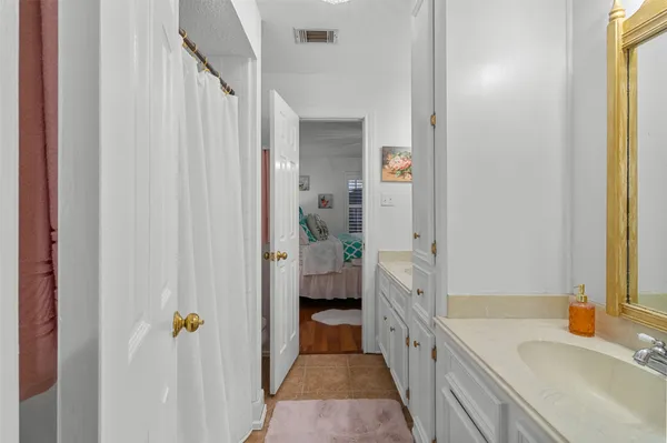 a living room with furniture kitchen view and a chandelier