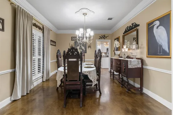 a view of a dining room with furniture and chandelier