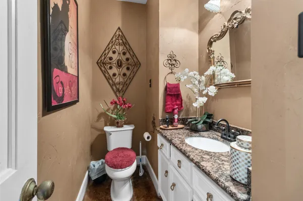 a living room with furniture a flat screen tv and a chandelier