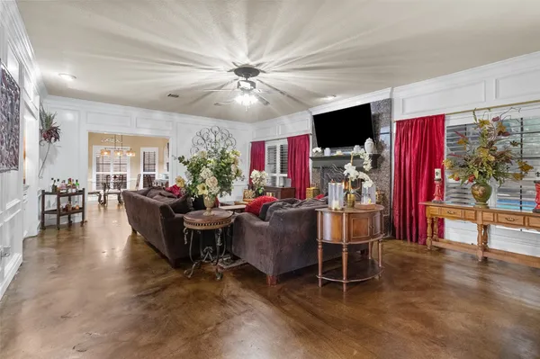 a living room with furniture a flat screen tv and kitchen view