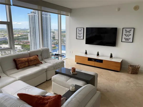 a living room with furniture and a flat screen tv